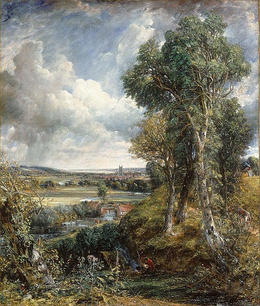 A landscape, with small houses in the distance.